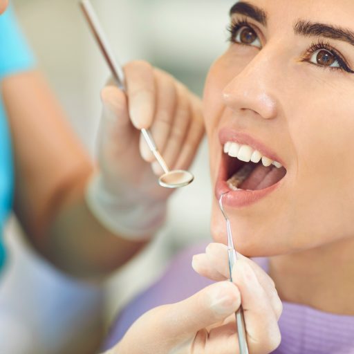 Dental treatment in the clinic. Dentist treats teeth to a young girl in the office of a dental clinic.